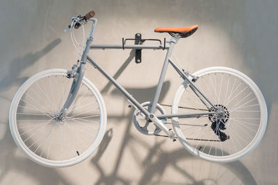 High angle view of bicycle parked against wall