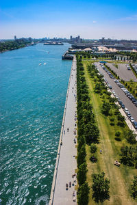 High angle view of sea by city against sky