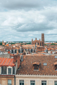 Houses in city against sky