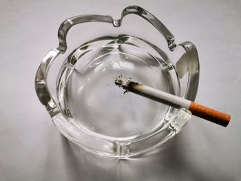 High angle view of cigarette on glass