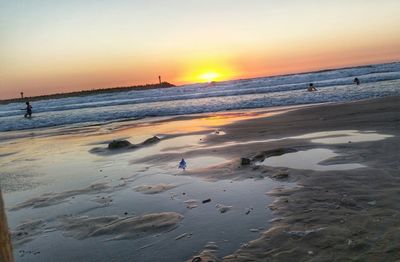 Scenic view of beach against sky during sunset