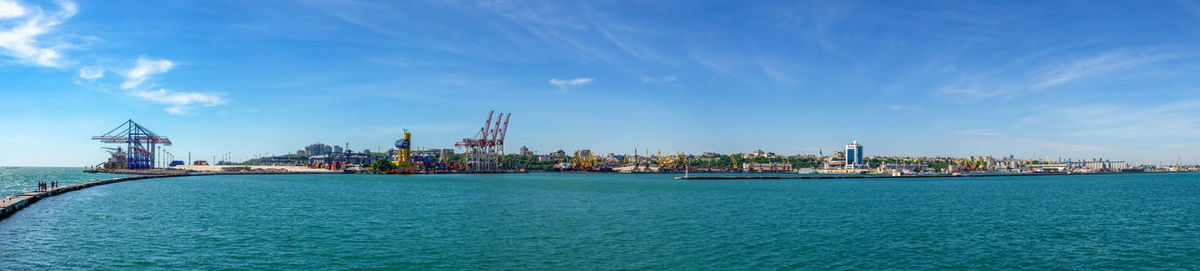 Lighthouse at the entrance to the harbor of odessa seaport, on a sunny summer day