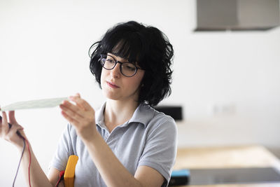 Young woman working as electronics technician