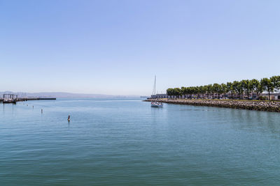 Scenic view of sea against clear blue sky