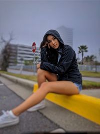 Young woman sitting outdoors