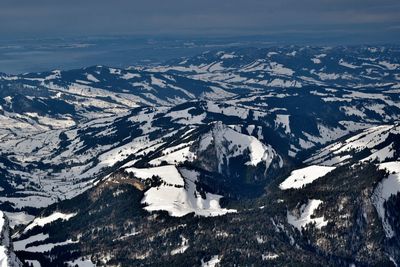 Aerial view of snowcapped mountains against sky