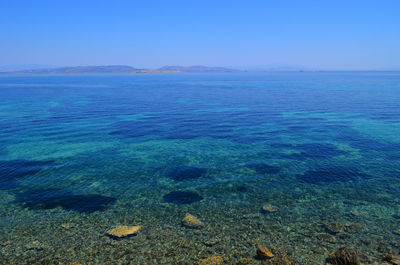 Scenic view of sea against clear blue sky