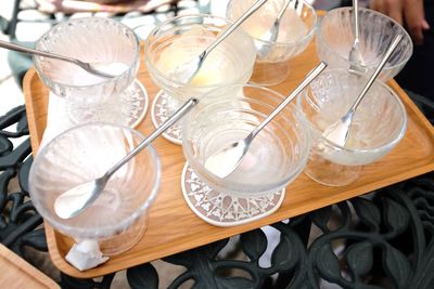 High angle view of spoons and bowl in tray on table