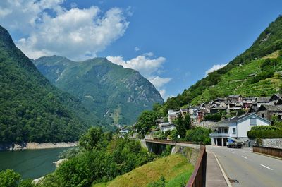 Scenic view of river by mountains against sky