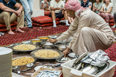 People sitting at market stall