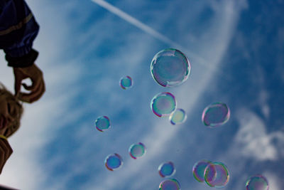 Low angle view of bubbles against sky