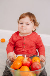 Portrait of cute girl with fruits