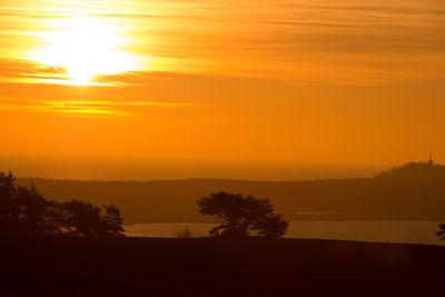 Scenic view of sea against orange sky