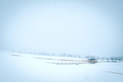 Frozen lake against clear sky