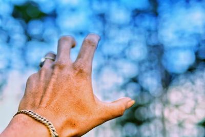 Cropped hand of man gesturing outdoors