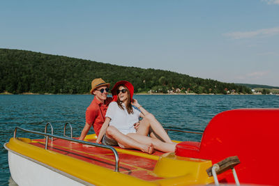 People on boat against sea