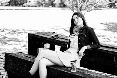 Beautiful young woman sitting at park