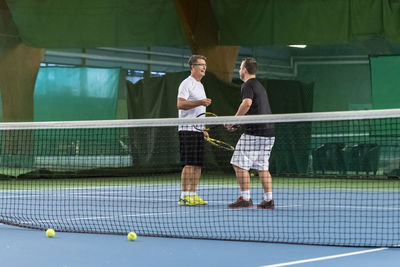 Men on tennis court