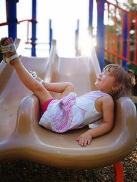 Rear view of girl sitting on floor