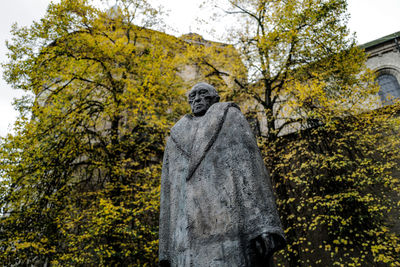 Low angle view of statue against trees