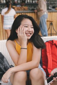 Close-up of young woman sitting at restaurant