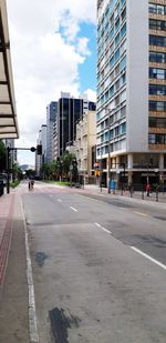 City street by buildings against sky