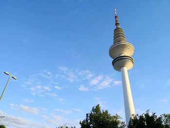 Low angle view of communications tower against sky