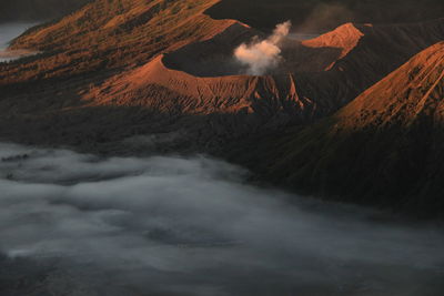 Scenic view of volcanic mountain against sky. thick fog enveloped mount bromo