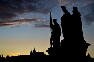 Silhouette statues against the sky