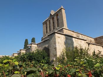 Low angle view of building against clear blue sky