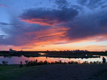 Scenic view of lake against sky during sunset