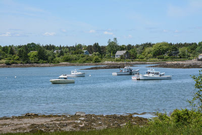 Boats in sea against sky