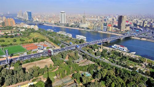 High angle view of bridge over river amidst buildings in city