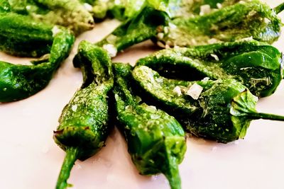 Close-up of fried green chili peppers on plate