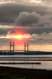 View of suspension bridge against cloudy sky