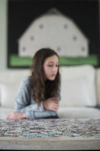 Portrait of young woman sitting on table