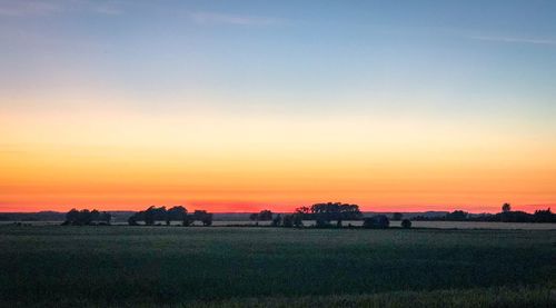 Scenic view of field against sky during sunset