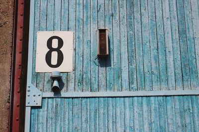 Close-up of text on blue door