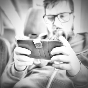 Close-up of man using mobile phone