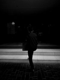 Full length of woman standing in illuminated city