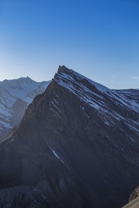 Scenic view of snowcapped mountains against clear sky