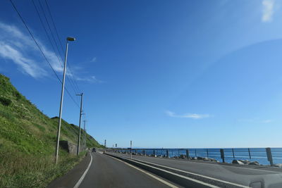 Road by sea against sky