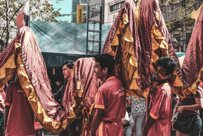 Group of people walking on street in city