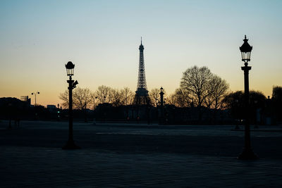 Street lights in city at sunset