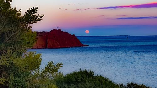 Scenic view of sea against sky at sunset