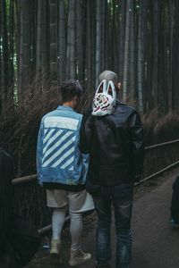 Rear view of couple standing in forest