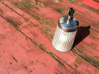 High angle view of glass container on table