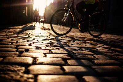 Low section of man riding bicycle on street