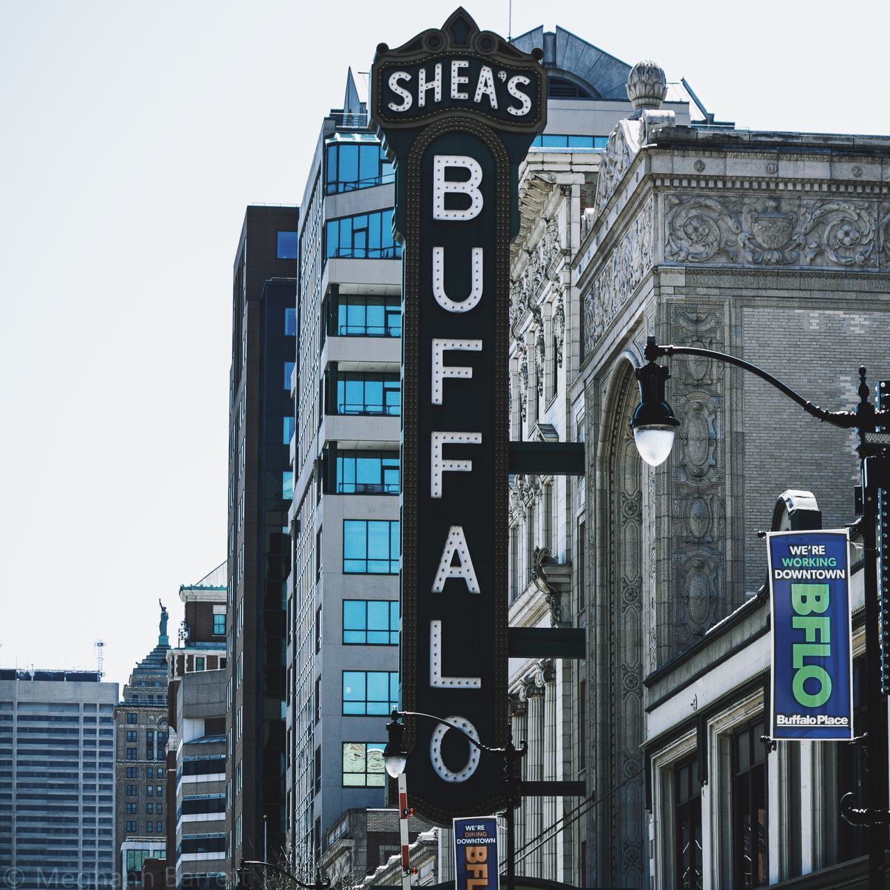 LOW ANGLE VIEW OF ROAD SIGNS AGAINST BUILDINGS