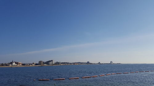 Scenic view of sea against blue sky